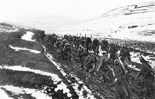 “Hills bare of trees, from which the snow that ran down their slopes
had turned the road into a sea of mud.”