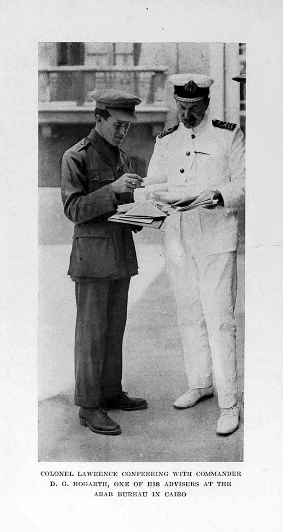 Photograph: COLONEL LAWRENCE CONFERRING WITH COMMANDER
    D. G. HOGARTH, ONE OF HIS ADVISERS AT THE ARAB BUREAU IN CAIRO